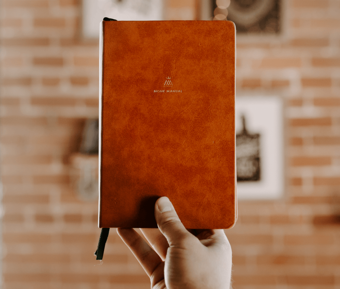 Monk Manual held in hand